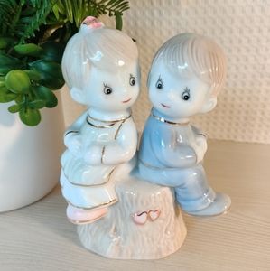 Ceramic figurine, girl and boy sitting on a tree stump